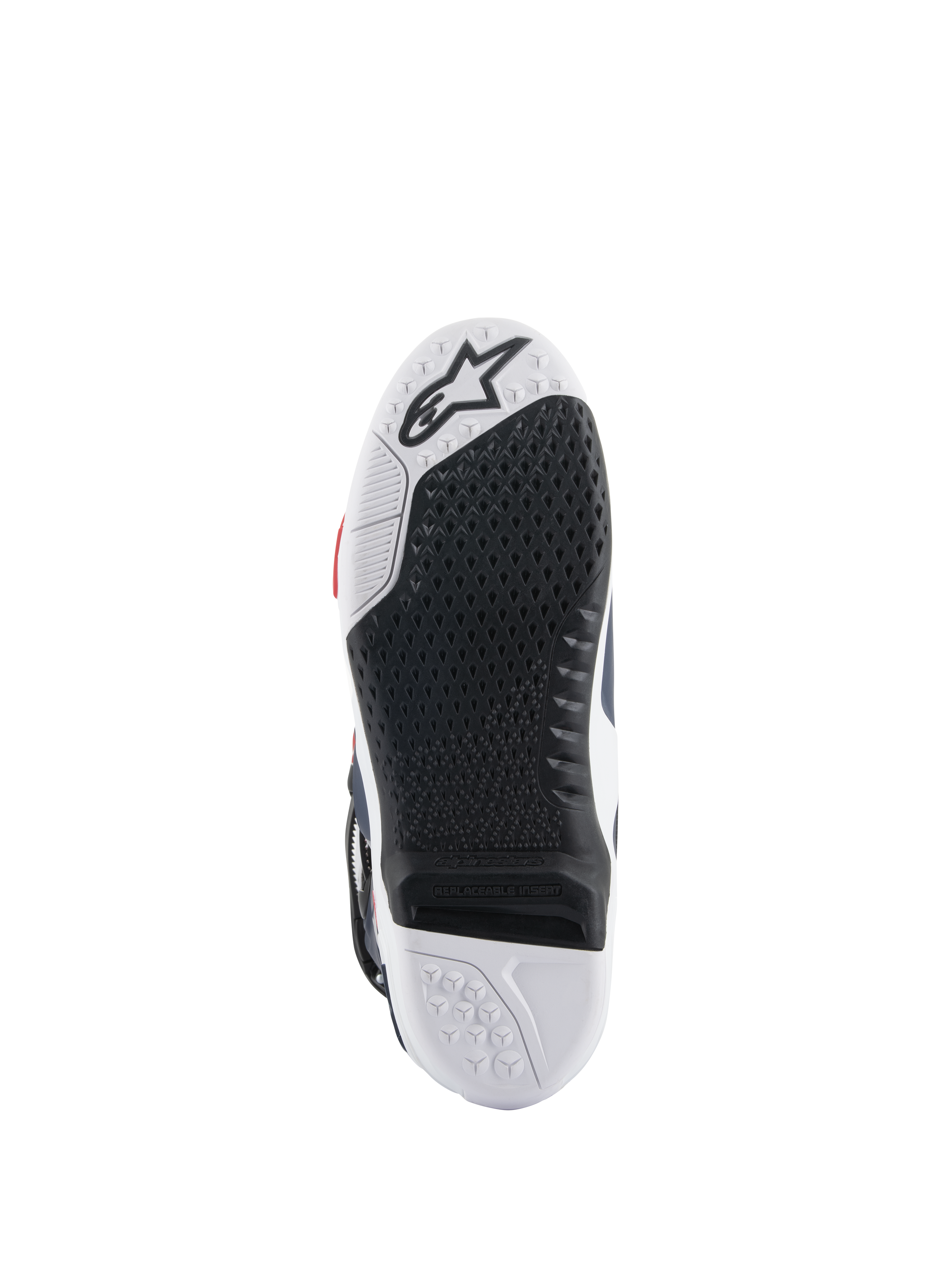 Alpinestars Tech 10 Supervented laarszool, onderaanzicht met een zwart-wit dual-compound ontwerp, honingraat gripstructuur, vervangbaar centraal inzetstuk en Alpinestars-logo in reliëf, geoptimaliseerd voor motorcross voetsteunprestaties.