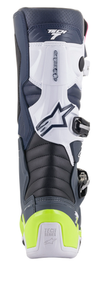 Alpinestars Tech 7 Laarzen, motorcrosslaarzen, achteraanzicht in donkerblauw, wit en donkergrijs met een felgele fluo hielbeschermer, voorzien van accordeon-flexzones en Tech Series-branding.