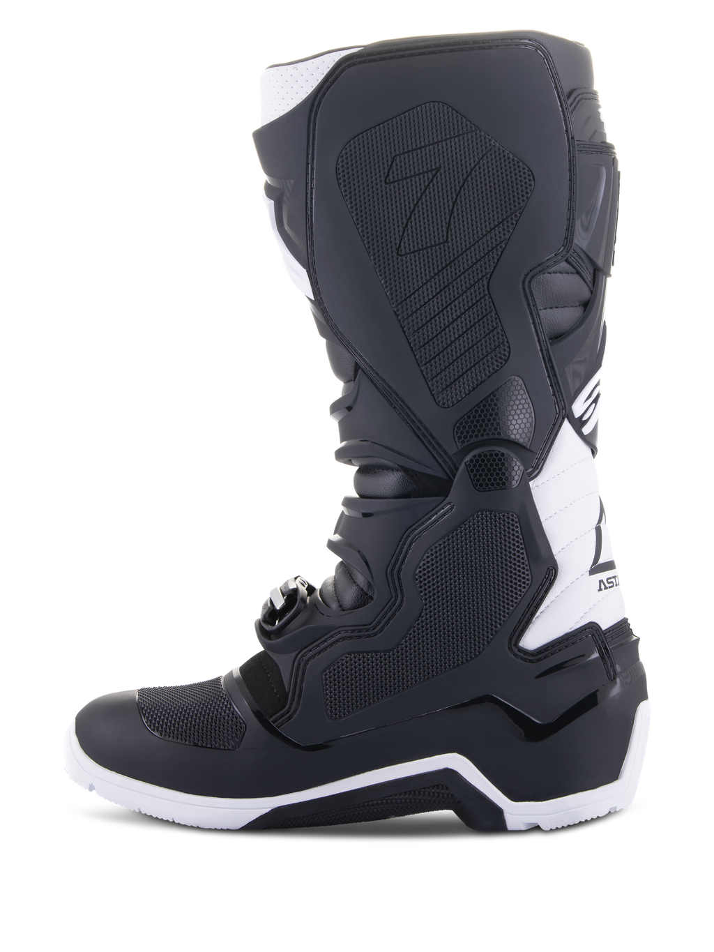 Alpinestars Tech 7 Enduro Drystar® laarzen, enduro motorlaarzen, zwart en wit, zijaanzicht van de mediale zijde met grippanelen met honingraatstructuur, TPU-constructie en witte accenten op de hiel en kuit, professioneel off-road schoeisel