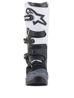 Bottes Alpinestars Tech 5, bottes de motocross, noir, gris foncé et blanc, vue de face présentant un système de fermeture à boucles multiples, panneau supérieur blanc avec logo Astars noir, bout renforcé gris foncé et discrets accents jaunes