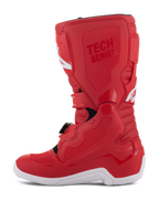 Bottes Alpinestars Youth Tech 7S, bottes de motocross pour enfant, rouge, avec semelle blanche, panneaux renforcés en TPU, multiples fermetures à boucles et marquage 'TECH SERIES', conçues pour les jeunes pilotes tout-terrain