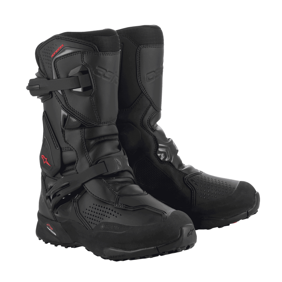 A pair of black/black XT-8 Gore-Tex high-top adventure enduro boots by Alpinestars EU, featuring red detailing. These boots boast a reinforced design with protective buckles and a rugged sole for enhanced grip. The Alpinestars logo is visible on the side, and the durable material makes them perfect for off-road riding.