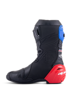 Alpinestars Honda Supertech R laarzen, motor-racelaarzen, zwart met felrode en blauwe accenten, met een opvallende rode TPU-hielslider, blauwe gaiter en Alpinestars-branding, technisch ontwerp voor professionele circuit- en wegprestaties.