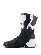 Alpinestars Stella SMX-6 V3 Drystar® laarzen, performance motorlaarzen voor dames, wit en zwart, mediale zijde met reliëf Drystar-branding, witte TPU-scheenbeen- en hielbescherming en gestroomlijnd zwart microvezel bovenwerk voor prestaties op de baan en op straat.