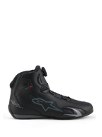 Alpinestars Celer Shoes, Motorcycle Riding Shoes, Black and Dark Gray, side profile view showing the Rotor Closure System dial on the tongue, technical microfiber upper with gray Alpinestars logo, streamlined sport and racing profile