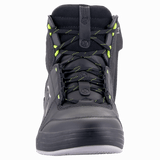 A pair of Chrome Drystar® Shoes by Alpinestars EU in black and dark gray with yellow fluo accents. These high-top shoes feature a logo resembling a stylized star on the sides and a decorative graphic detail near the heel. Perfect for the urban rider, they are laced up and set against a white background.