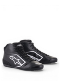 Chaussures Alpinestars Tech-1 K Start V2, chaussures de karting noires et blanches, dotées d'une tige légère en microfibre avec panneaux de ventilation perforés et logos Astars blancs.