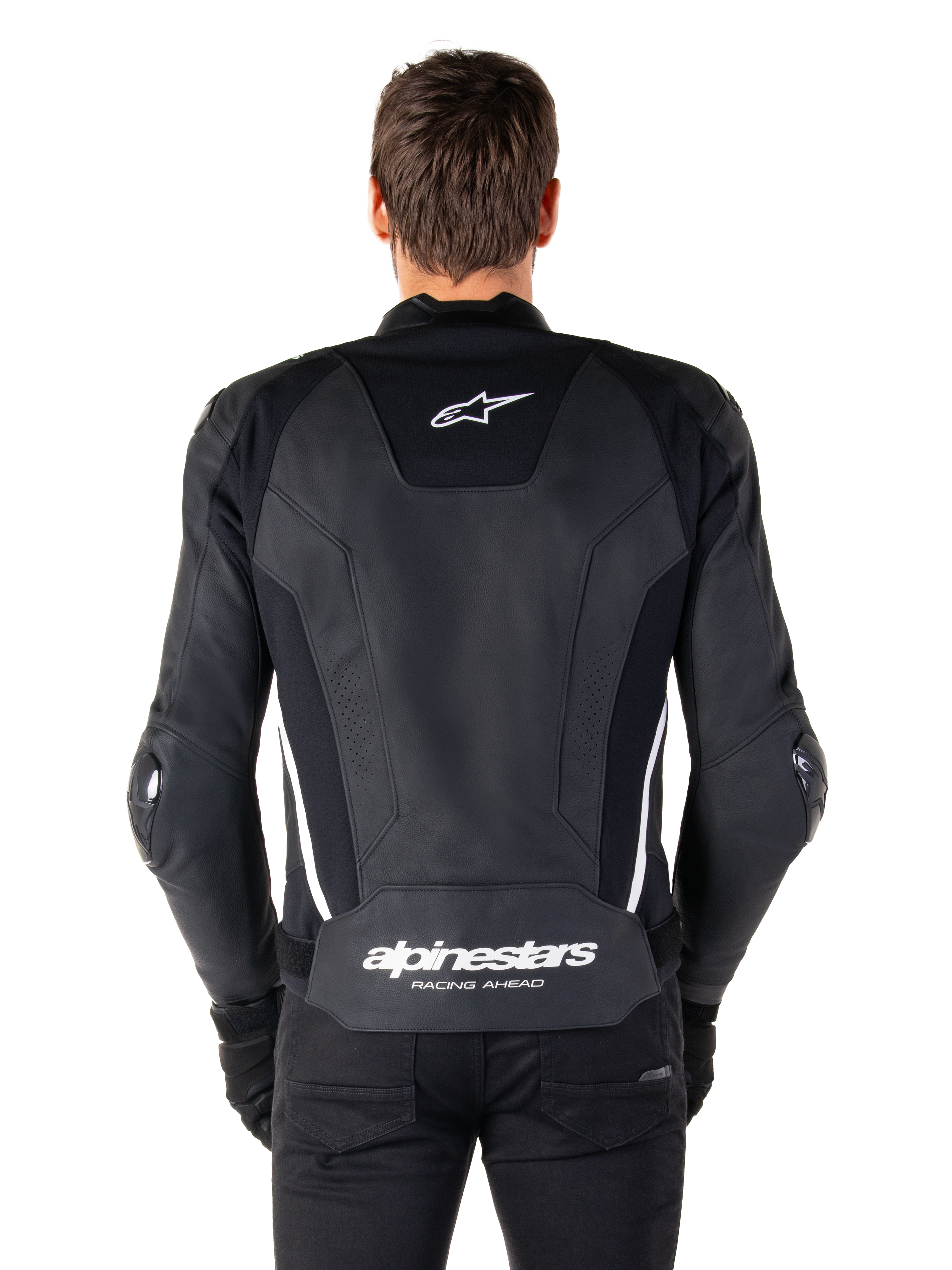 Vue arrière de la veste en cuir Alpinestars Missile V3 en noir et blanc, avec le logo étoile Alpinestars sur le haut du dos, le marquage sur la zone lombaire, des bandes verticales blanches et des sliders de coude externes, veste de sport racing en cuir premium.