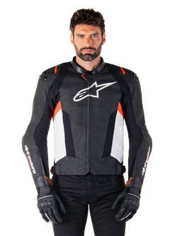 Alpinestars Missile V3 Leather Jacket, Black White and Red Fluo, premium racing sport jacket with bovine leather, featuring white chest logo and Alpinestars branding on sleeves, worn with black motorcycle gloves and pants