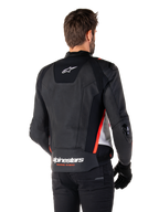 Alpinestars Missile V3 Leren Jas, achteraanzicht op een motorrijder, zwart wit en fluorood, met opvallende Alpinestars-branding en 'RACING AHEAD' tekst op de onderrug, hoogwaardige lederen constructie met technische stretchpanelen en beschermende TPU-sliders, gedragen met zwarte handschoenen en broek.