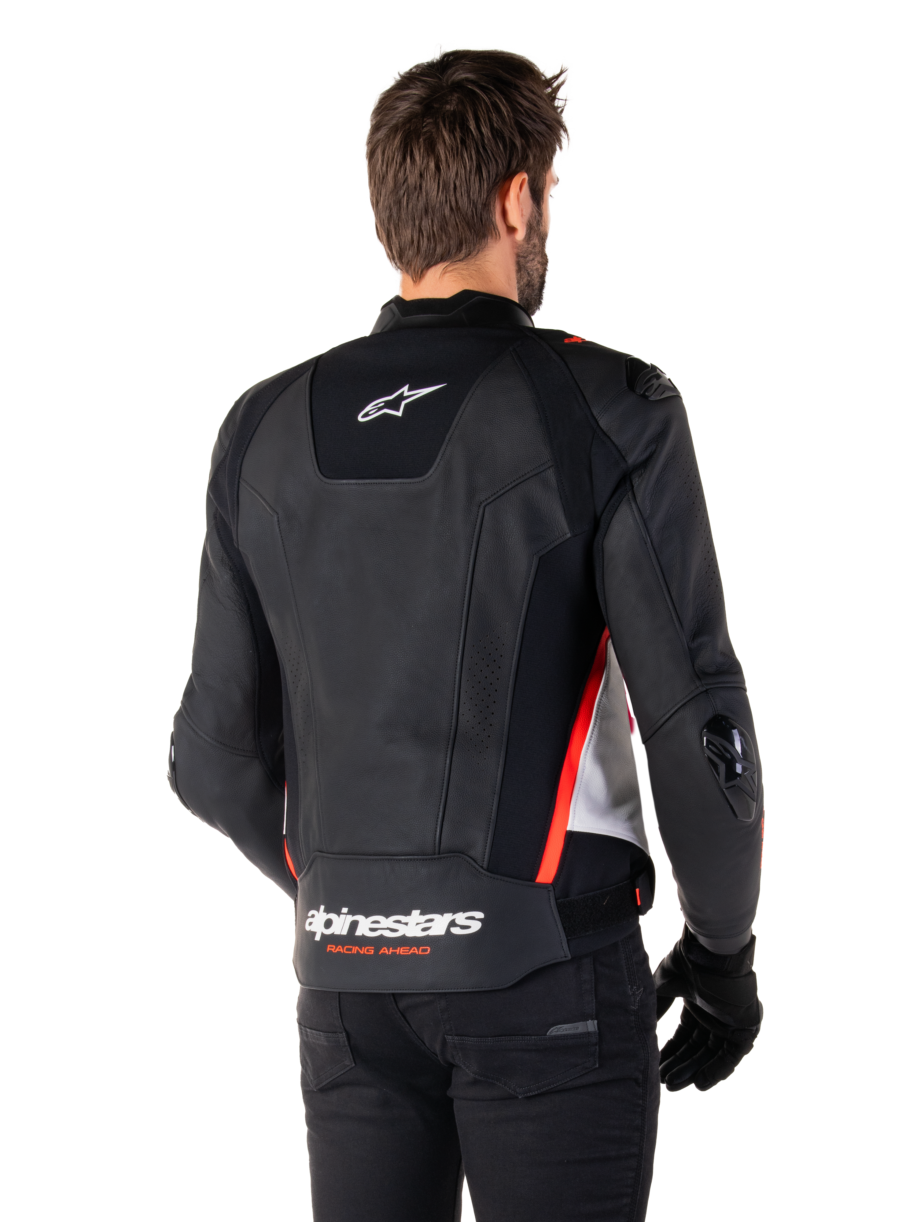 Alpinestars Missile V3 Leren Jas, achteraanzicht op een motorrijder, zwart wit en fluorood, met opvallende Alpinestars-branding en 'RACING AHEAD' tekst op de onderrug, hoogwaardige lederen constructie met technische stretchpanelen en beschermende TPU-sliders, gedragen met zwarte handschoenen en broek.