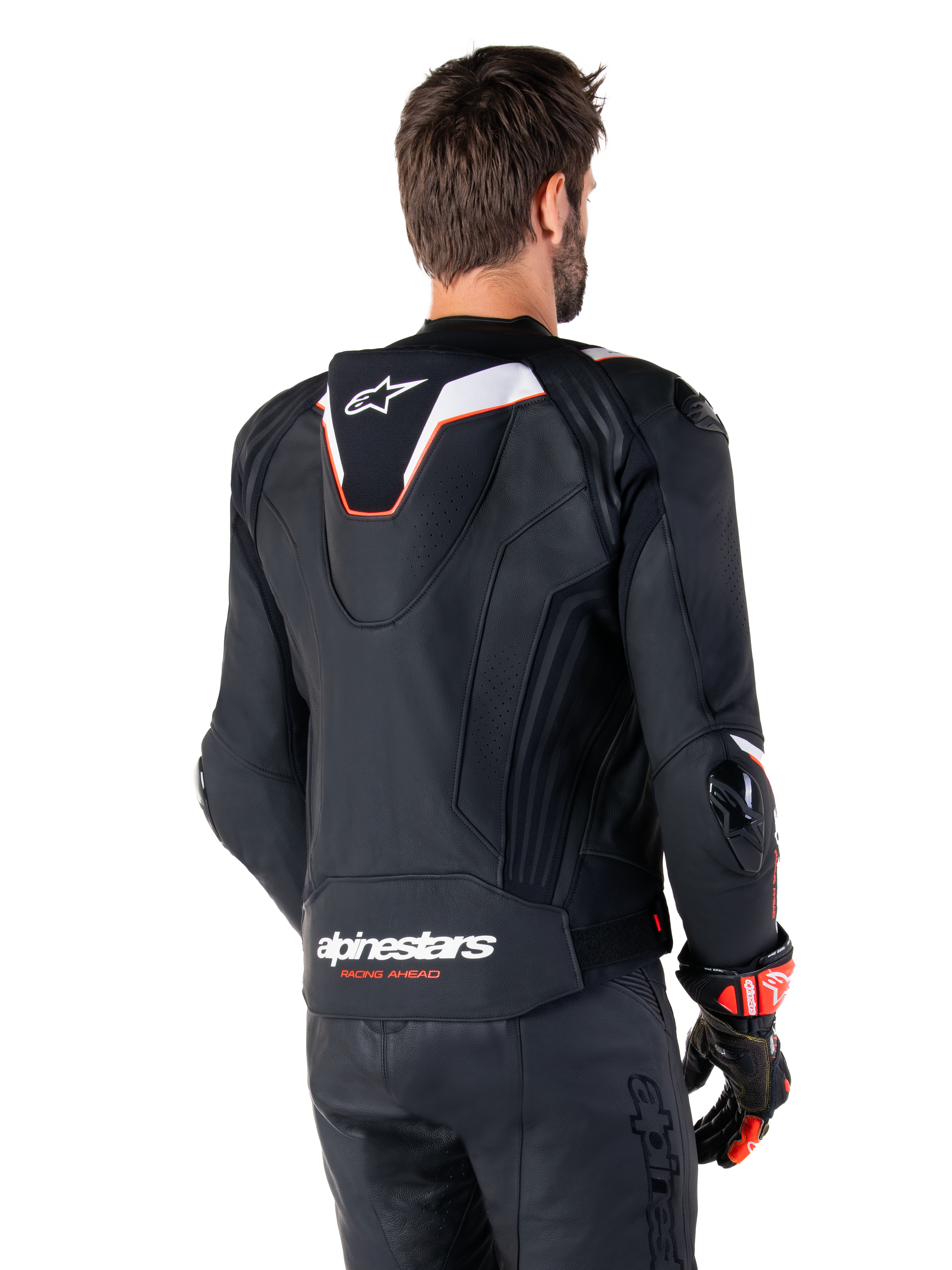 Alpinestars Missile V3 Ignition Lederjacke, Rückansicht, Schwarz mit weißen und roten Akzenten, mit schmalem Sport-Aero-Höcker und Alpinestars-Branding, getragen mit passender Lederhose und Rennhandschuhen