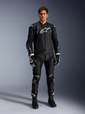 Alpinestars Missile V3 Leather Pants, Black, worn by a male rider as part of a complete leather motorcycle racing outfit, featuring white Alpinestars branding, protective knee sliders, racing boots, and gloves.