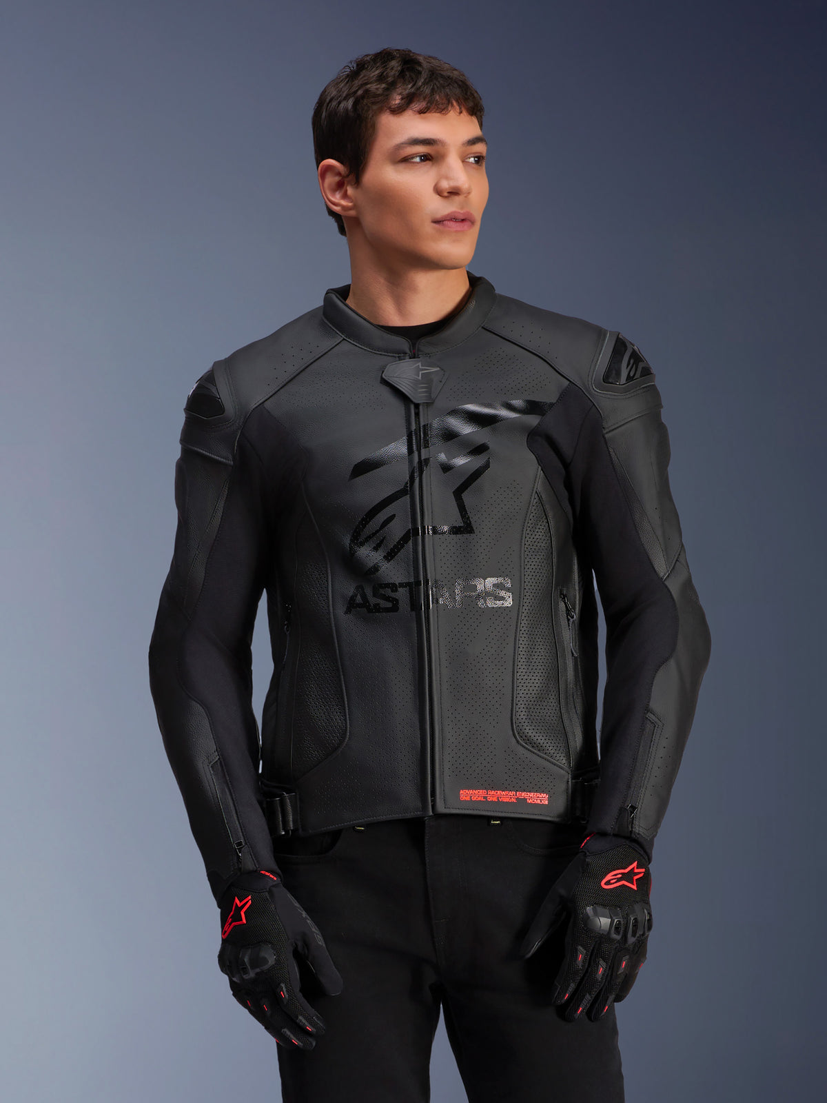 Alpinestars GP Plus R V4 Airflow Leather Jacket, Black, Motorcycle Racing Jacket with perforated leather construction, featuring prominent ASTARS chest branding and DFS shoulder protection, worn with black and red gloves