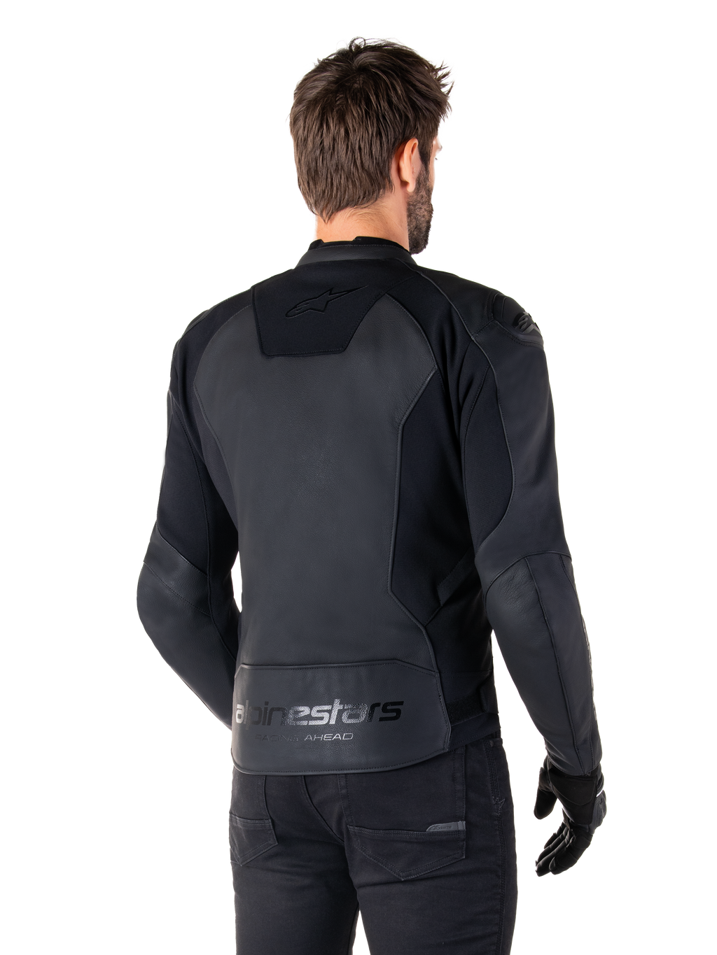 Alpinestars Faster V3 Lederjacke, Schwarz, Rückansicht eines Models in der Sport-Motorradjacke, mit 'alpinestars' und 'RACING AHEAD' Branding am unteren Rücken, erstklassiges Leder mit matten Einsätzen, moderne sportliche Silhouette für das Motorradfahren