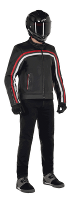Alpinestars Dyno Leren Jas, motorjas, zwart met Ruby Red en Ecru strepen, gedragen met een zwarte carbon-fiber helm en zwarte broek, voorzien van een op erfgoed geïnspireerd ontwerp met premium leer en een reguliere pasvorm