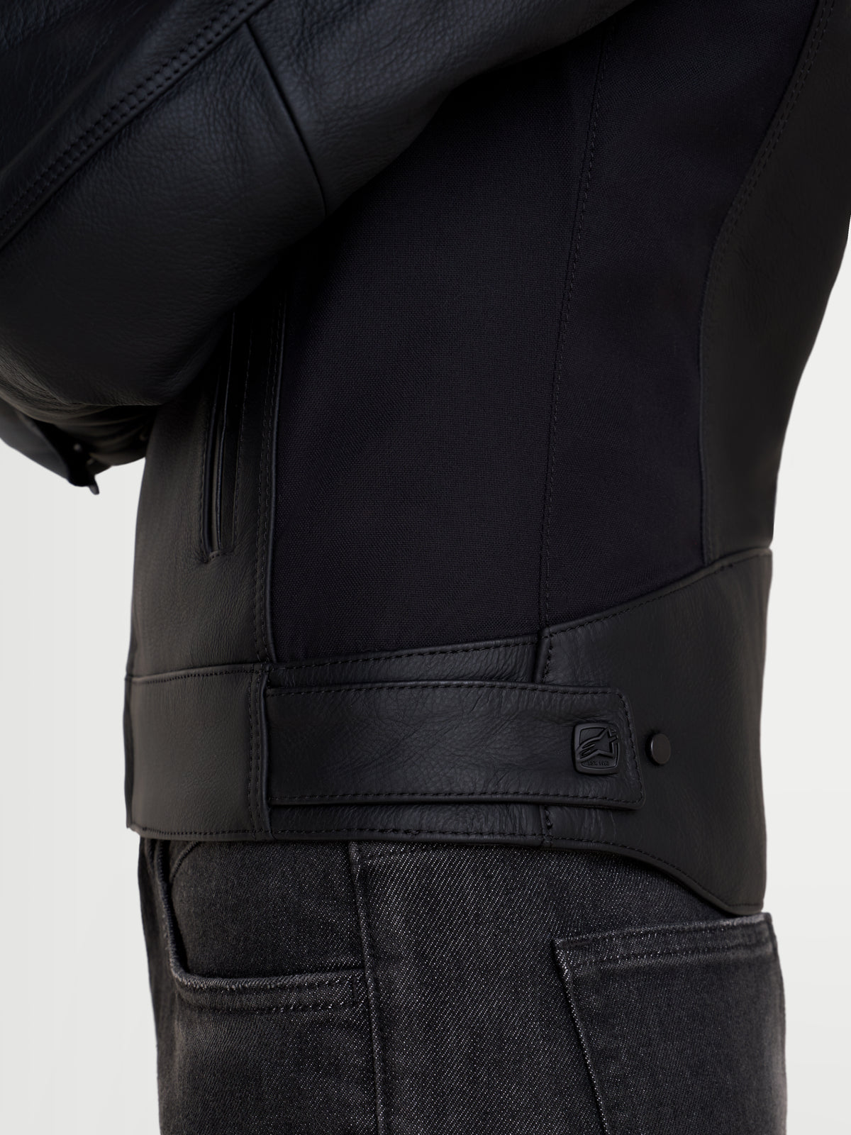 Alpinestars Stella Maver-X Leather Jacket, women's urban motorcycle jacket, black, close-up view of the side and waist adjustment tab with snap closure, premium leather and stretch construction