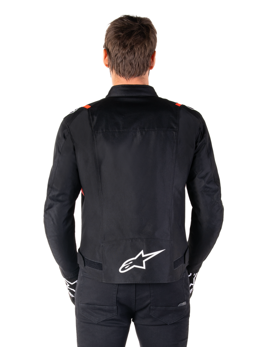 Alpinestars T-SPS V2 Waterproof Jacket, Black with White and Red Fluo accents, rear view featuring a large white Alpinestars logo on the lower back, sport cut textile motorcycle jacket, worn with black pants and gloves