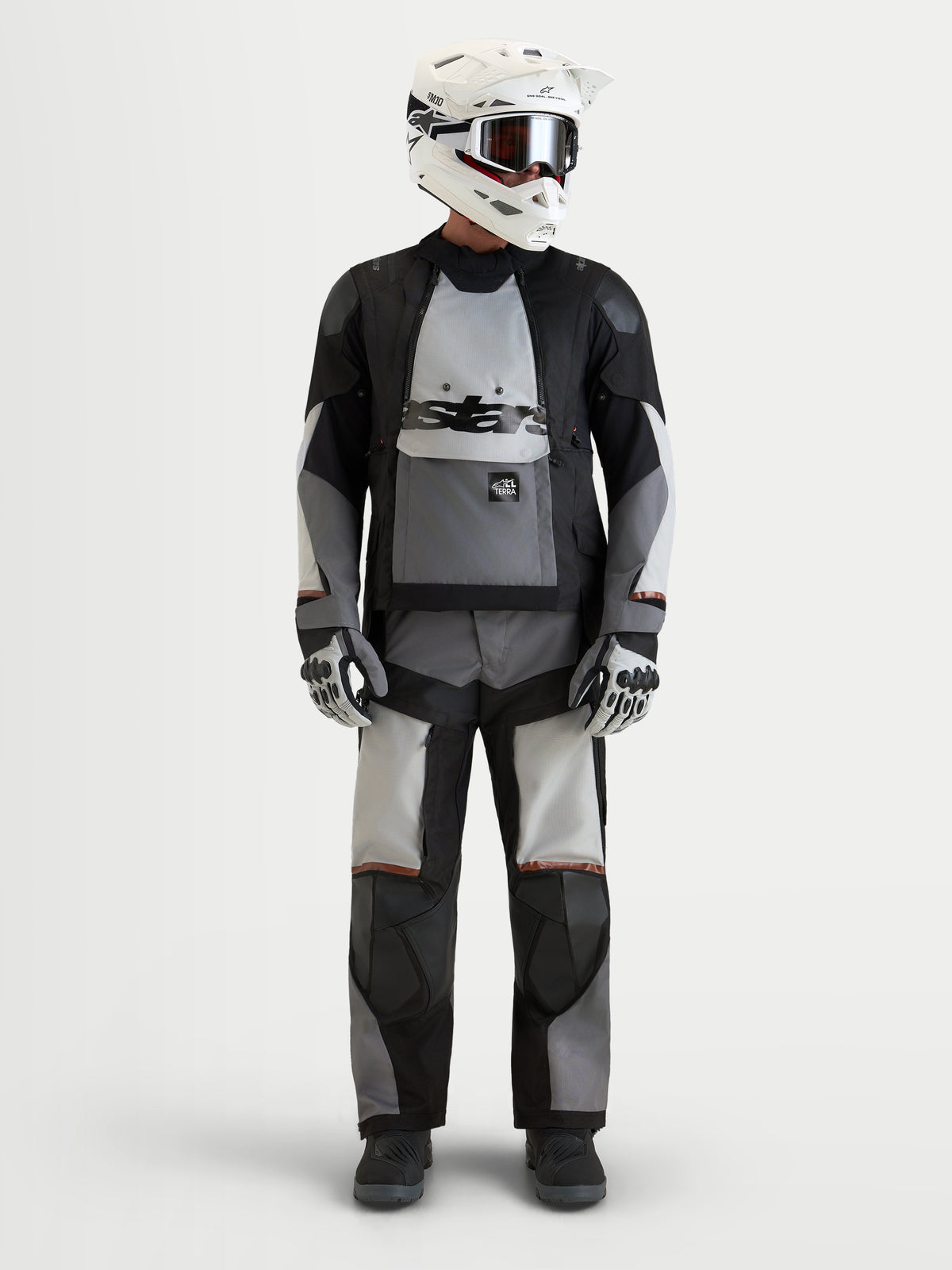 Alpinestars Harok V 2 Drystar jas, heren-adventure-motorjas in donkergrijs, ijsgrijs en zwart, gedragen met bijpassende rijuitrusting, helm en handschoenen, CE-gecertificeerd