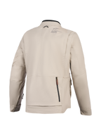 Veste Alpinestars Borrego Drystar®, veste de moto, Gris chaud, vue arrière montrant un grand compartiment zippé au dos, construction en toile textile durable avec logo Alpinestars sur l'épaule, design prêt pour l'aventure