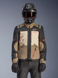 Alpinestars Andes V4 Drystar® Jacket, Walnut Mastic Black, adventure touring jacket featuring walnut brown and mastic cream panels, black sleeves, and bright orange accents, worn with a black motorcycle helmet, dark goggles, and black gloves