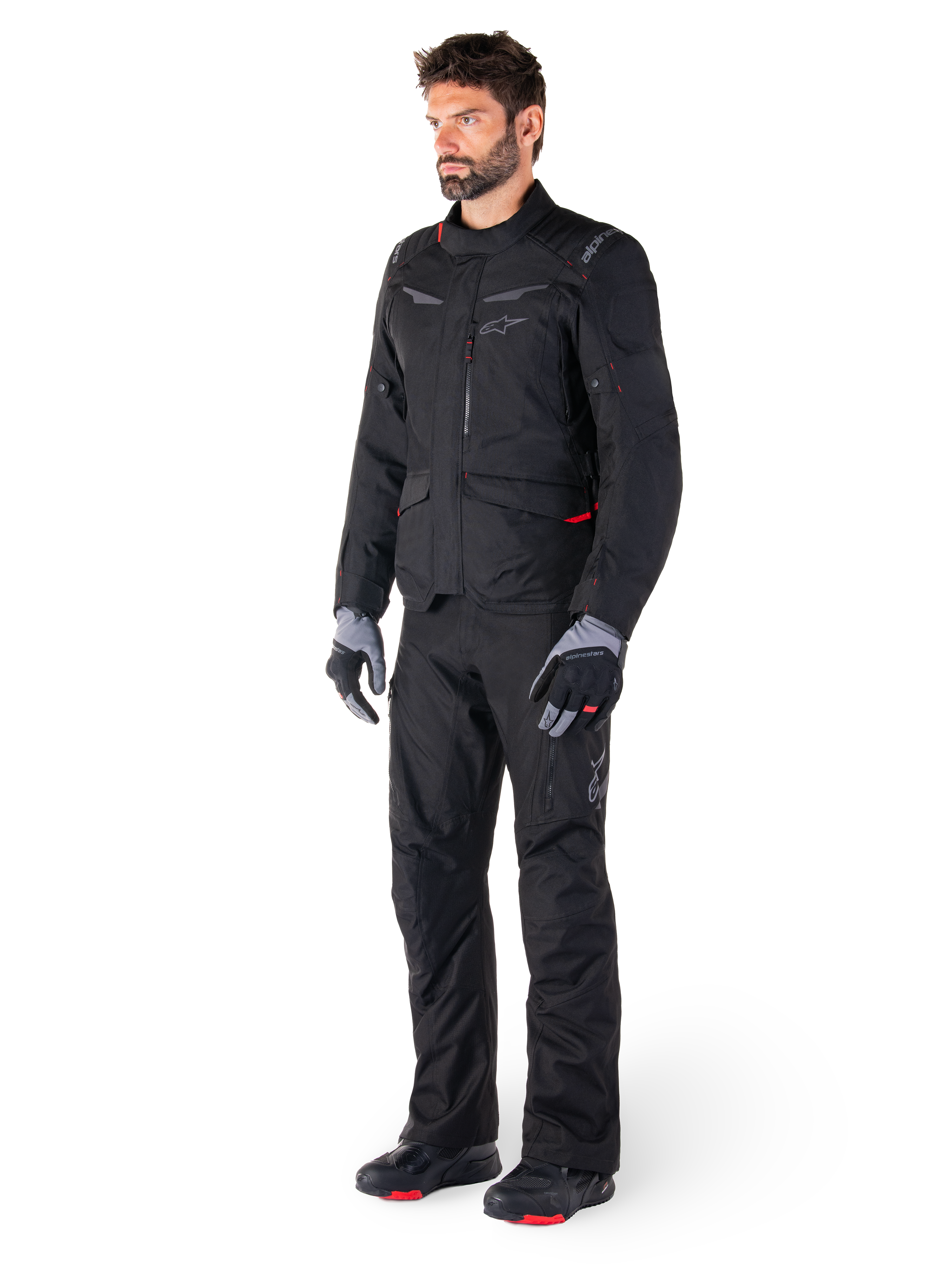 Alpinestars ST-1 Waterproof Jacket, Black, adventure touring jacket with red accents, worn with matching black pants, gloves and boots, full body view of rider in complete all-weather gear set