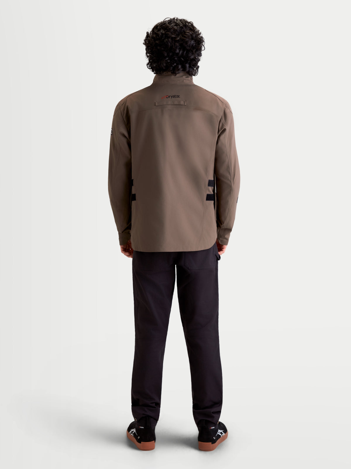 Alpinestars Altan Drystar Jacket, men's urban contemporary motorcycle textile jacket in walnut and black, rear profile view on a model showing the waterproof field-jacket construction and high collar.