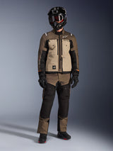 Alpinestars Cusco Drystar® Jacket, Walnut Aluminum Black, adventure touring motorcycle jacket worn with matching pants and a black helmet, featuring tan chest panels and brown ripstop sleeves, technical all-weather riding gear