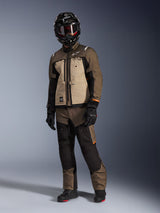 Alpinestars Cusco Drystar® Jacket, Walnut Aluminum Black, worn by a rider in full adventure touring gear, featuring tan and brown panels with black accents, coordinated with matching pants, a black full-face helmet with goggles, and black boots, studio background