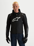 Alpinestars Zaca V2 Waterproof Jacket, Men's Black and White textile motorcycle racing and sport jacket with integrated hood and shoulder armor, worn by a model