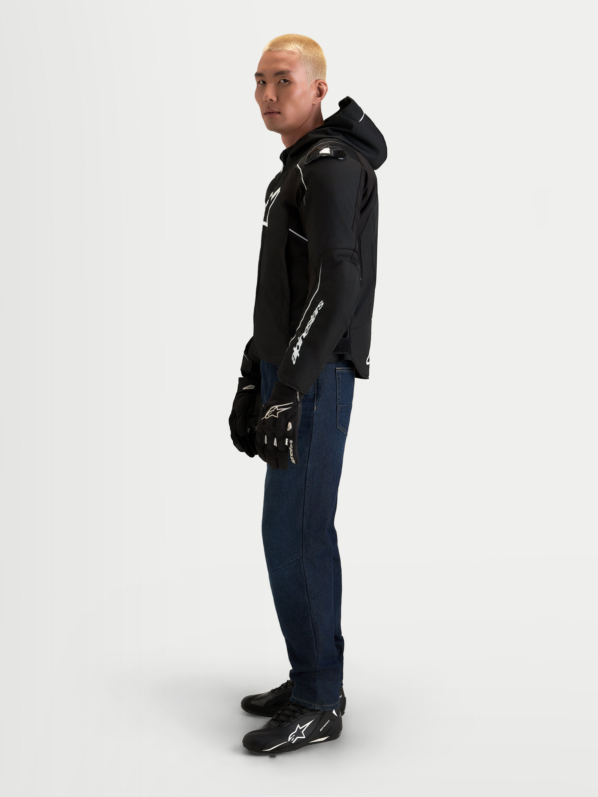 Alpinestars Zaca V2 Waterproof Jacket, Men's motorcycle waterproof textile jacket, Black and White, CE certified with Nucleon armor, worn by a model in profile view