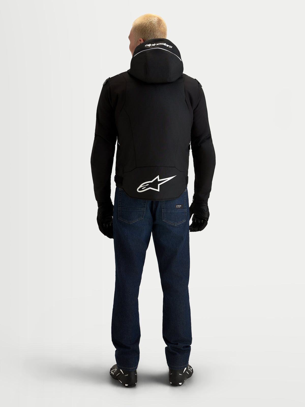 Alpinestars Zaca V2 Waterproof Jacket, Men's Black and White motorcycle jacket, back view showing an integrated hood with Alpinestars branding, extended rear hem with a large white Astar logo, and waterproof textile construction for road riding