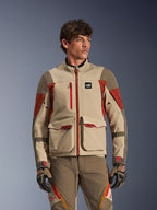 Alpinestars Maxdura Drystar®XF Laminated Armored Shell, Aluminum Walnut Rust Brown, Adventure motorcycle jacket worn by a male model, featuring large front cargo pockets and technical red accents, paired with matching adventure riding pants and gloves