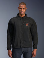 Alpinestars Revved WR Jacket, zwarte motorjas met een overhemdkraag en drukknoopsluiting aan de voorzijde, rood geborduurd 'A'-logo op de borst, verticale borstzak met rits, elastische manchetten, urban coaches jacket ontwerp