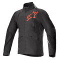 Alpinestars Hyde XT Drystar XF motorjas, zwarte en felrode technische motorjas, groot rood sterlogo op de borst, verticale ventilatieritsen op de borst, hoge kraag, getextureerde vierwegstretchstof, ontworpen voor adventure en off-road rijden