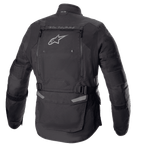 Veste Alpinestars Bogotá Pro Drystar®, vue arrière, noire, veste de moto en textile avec grand panneau de ventilation arrière, logo Alpinestars, marquage « TECH TOURING », sangles de réglage à la taille et panneaux en accordéon aux coudes.