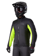 Alpinestars Bogotá Pro Drystar® Jacket waterproof liner, black with bright yellow fluo accents on the sleeves, worn by a rider with a black helmet and goggles, technical motorcycle apparel.