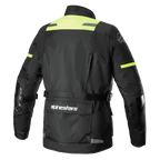 Alpinestars Andes V3 Drystar® Jacket, back view of adventure motorcycle jacket in Black and Yellow Fluo, featuring a large lower back utility pocket with Alpinestars logo, high-visibility shoulder panels, and adjustable waist straps.