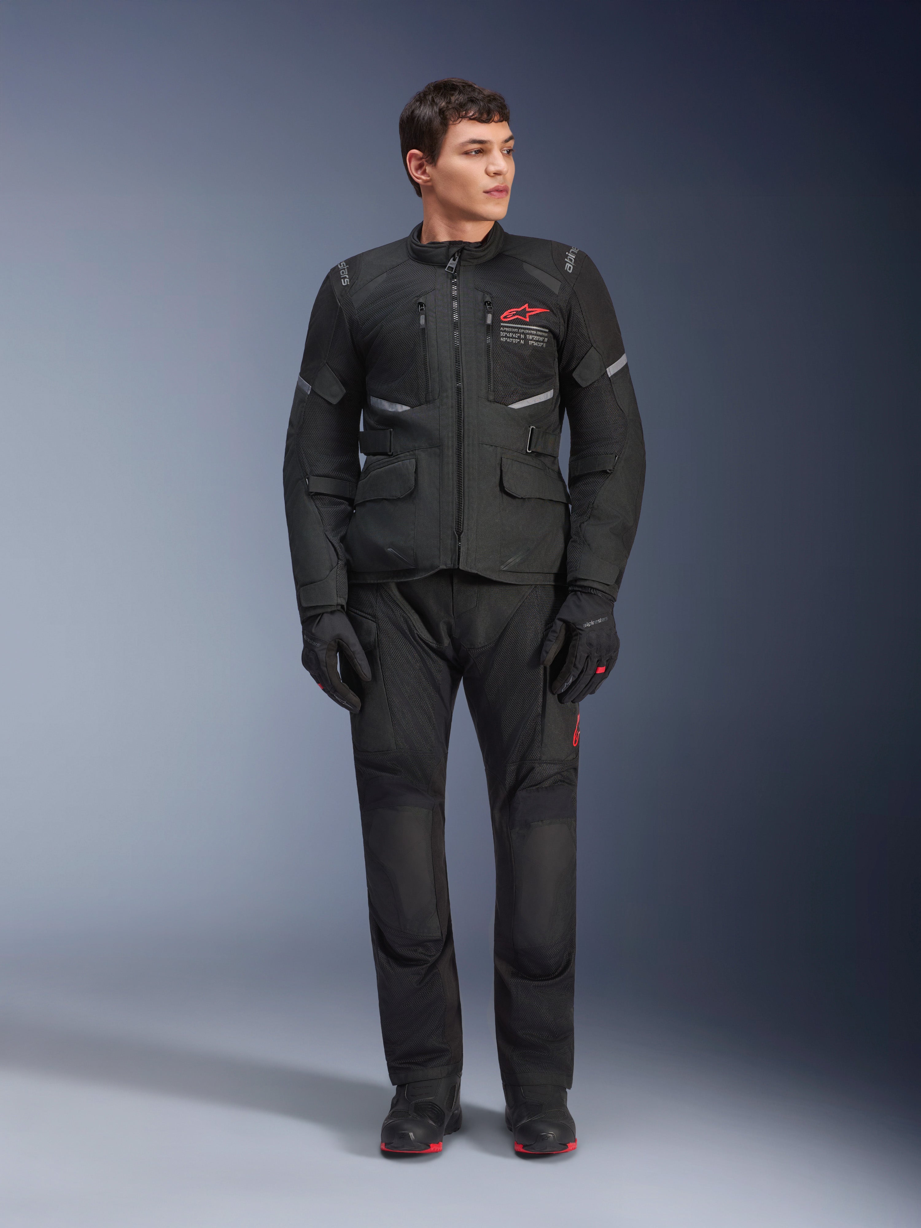 Alpinestars Andes Air Drystar® Pants, Motorcycle Touring Pants, Black, featuring mesh ventilation panels and a red logo on the leg, worn as part of a complete riding outfit with a matching jacket and gloves, professional adventure touring gear