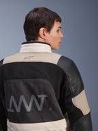 Alpinestars AMT-10LAB Drystar® XF Jacket, back view on male model, White Sand Aluminum Camo and black colorway, featuring large AMT branding, mesh ventilation panels, and leather reinforcements, technical adventure motorcycle apparel