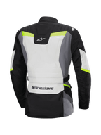 Alpinestars Stella ST-1 Waterproof Jas, achteraanzicht, adventure touring motorjas voor dames, Ice Gray, zwart en geel fluo, voorzien van Alpinestars logo op de onderrug en nek, beschermende textielconstructie met fluorescerende accenten.