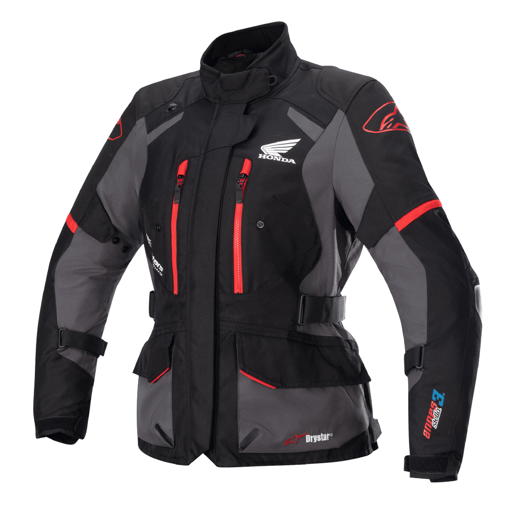 Alpinestars Stella Honda Andes V3 Drystar pour femme, veste de touring moto, noire et grise avec accents rouge vif, logo Honda Wing sur la poitrine, fermetures éclair rouges, sangles de réglage à la taille et aux bras, construction imperméable durable