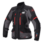 Alpinestars Stella Honda Andes V3 Drystar pour femme, veste de touring moto, noire et grise avec accents rouge vif, logo Honda Wing sur la poitrine, fermetures éclair rouges, sangles de réglage à la taille et aux bras, construction imperméable durable