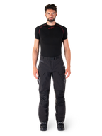 Alpinestars Hyde XT Drystar® Hose, Adventure-Touring-Motorradhose, Schwarz, getragen von einem Model mit schwarzem kurzärmeligem Base Layer und schwarzen Stiefeln, mit technischem Stretchmaterial, verstärkten Knieeinsätzen und ergonomischen Cargo-Taschen.