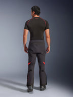 Alpinestars Halo Pro Drystar® XF Laminated Pants, Adventure Motorcycle Pants, Black Dark Shadow with red highlights, rear view worn with a black short-sleeve base layer and black adventure boots, showcasing a durable 3-layer laminated construction and ergonomic fit.
