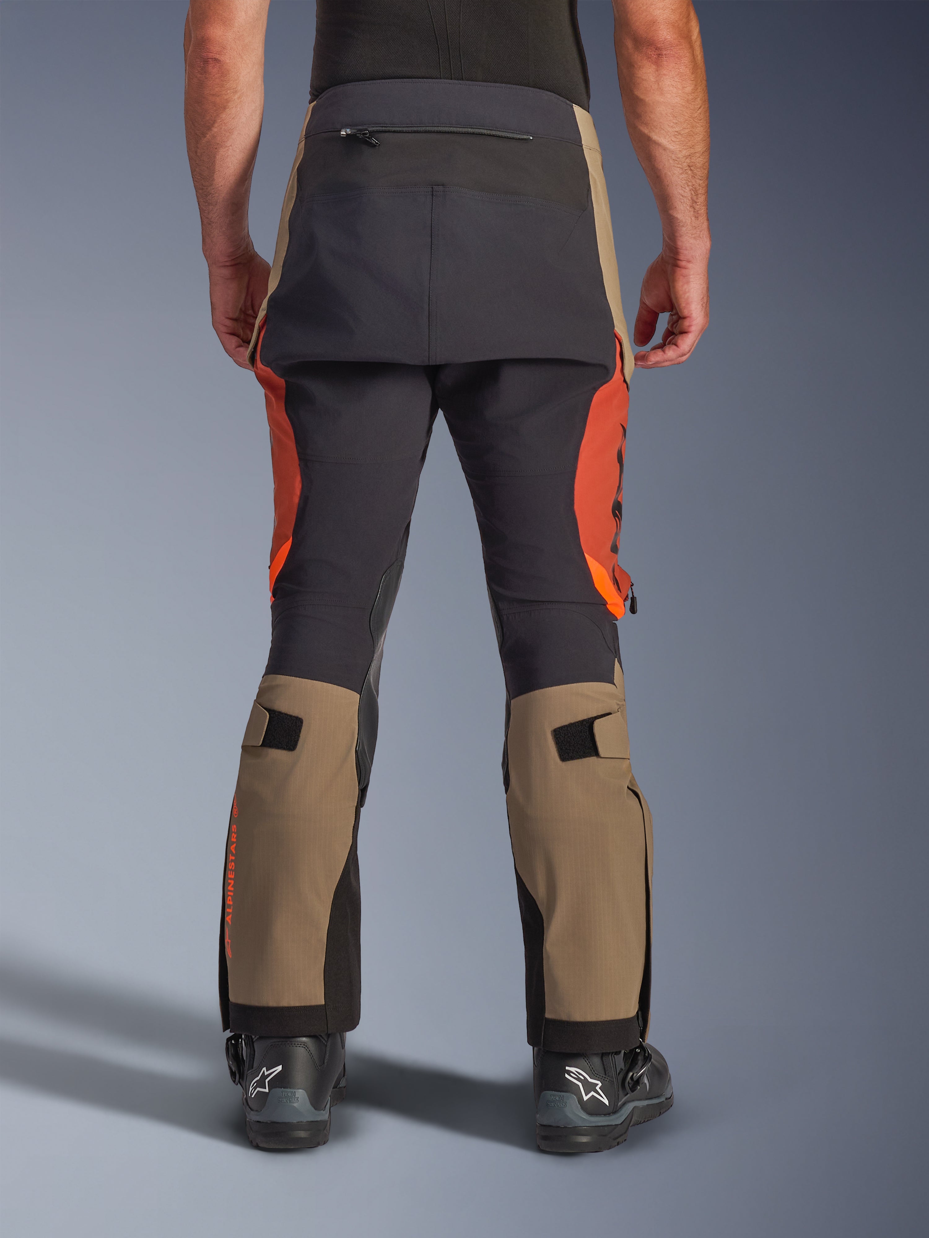 Alpinestars Halo Pro Drystar® XF gelamineerde broek in Walnut Rust Black, achteraanzicht, adventure motorbroek met walnootbruine en roestoranje panelen, zwarte versteviging op het zitvlak, inclusief achterzak met rits en verstelbare banden voor het kuitvolume