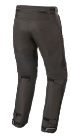 Pantalon Alpinestars Raider V2 Drystar®, pantalon de moto en textile, noir, vue arrière montrant la fermeture éclair de connexion à la taille et les sangles Velcro réglables à l'arrière des jambes et des chevilles