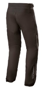 Alpinestars AST-1 V2 Waterproof Pants, Black, textile motorcycle pants, rear-side view showing reflective details, lower leg Alpinestars logo, waist connection zipper, and adjustable cuffs for all-weather protection