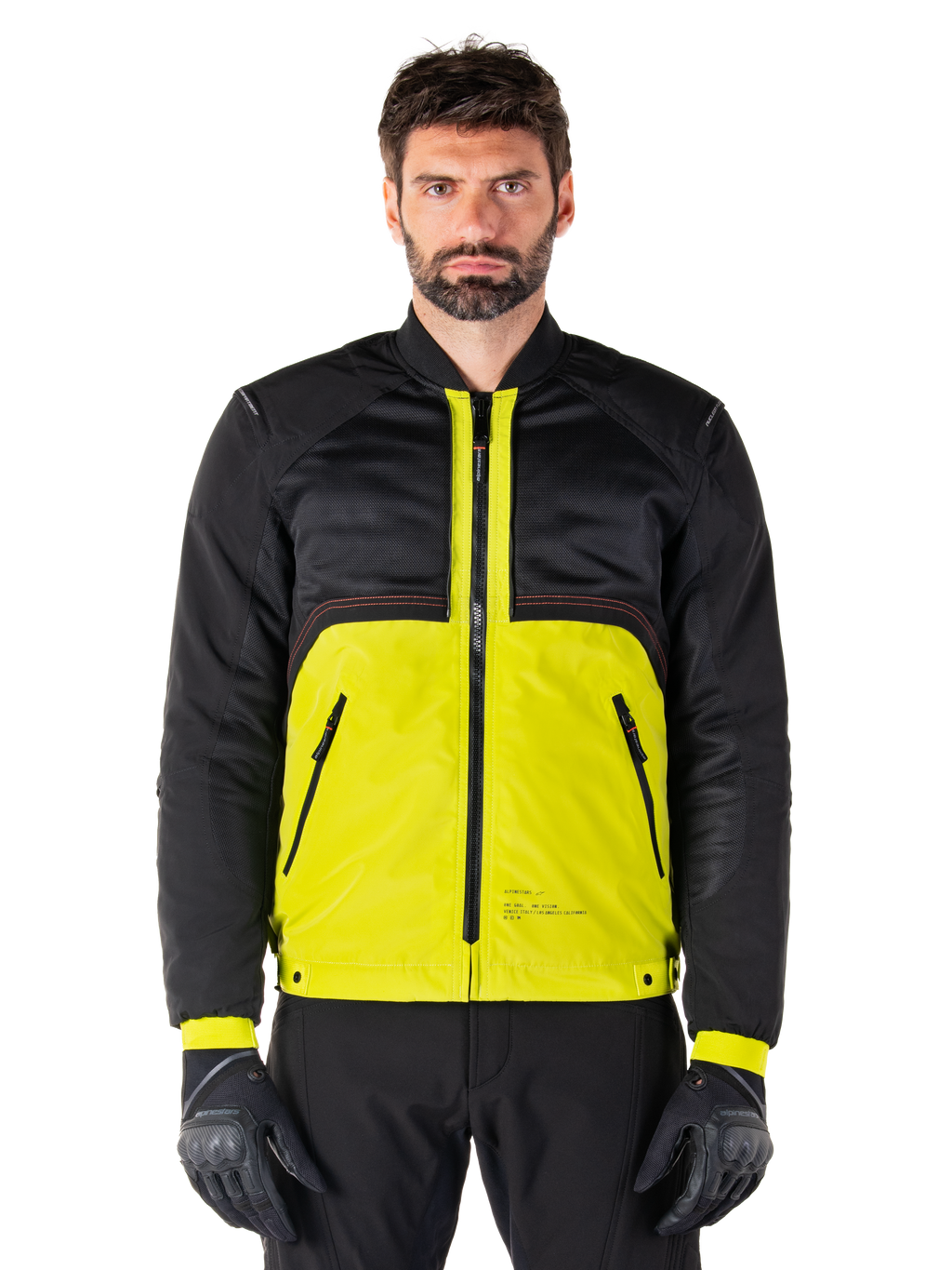 Mootant Waterproof Parka, modulaire motorjas, Lime Punch en zwart, gedragen door een mannelijk model met zwarte handschoenen en broek, met een felgeel onderlichaam en een zwart bovenstuk en mouwen, utilitair ontwerp voor rijden in alle weersomstandigheden
