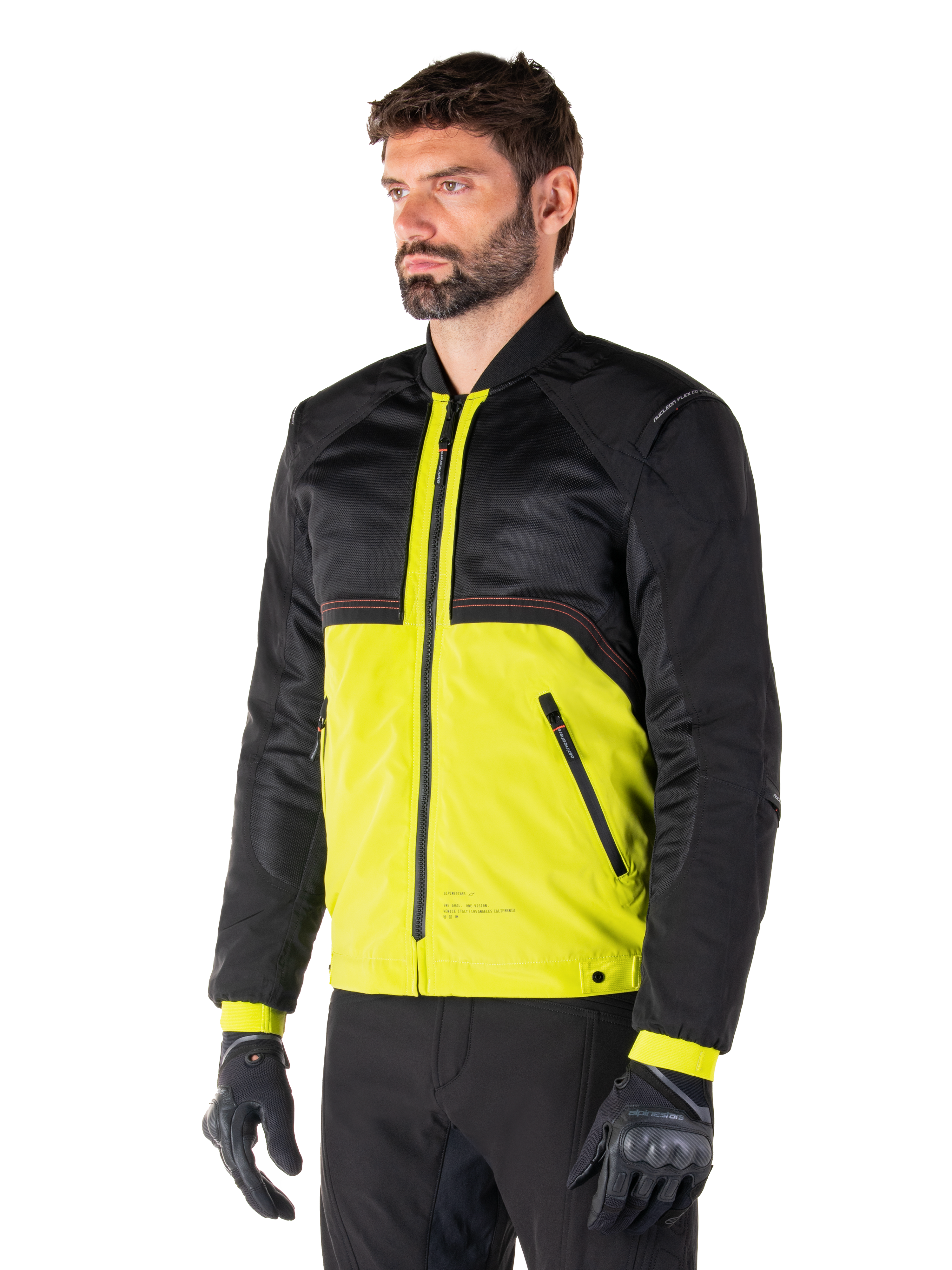 Alpinestars Mootant Waterproof Parka in Lime Punch Black, modulaire motorjas met een zwart mesh bovenstuk en een opvallend limoengroen onderstuk, gedragen door een mannelijke motorrijder met zwarte handschoenen en broek, urban contemporary rijstijl.